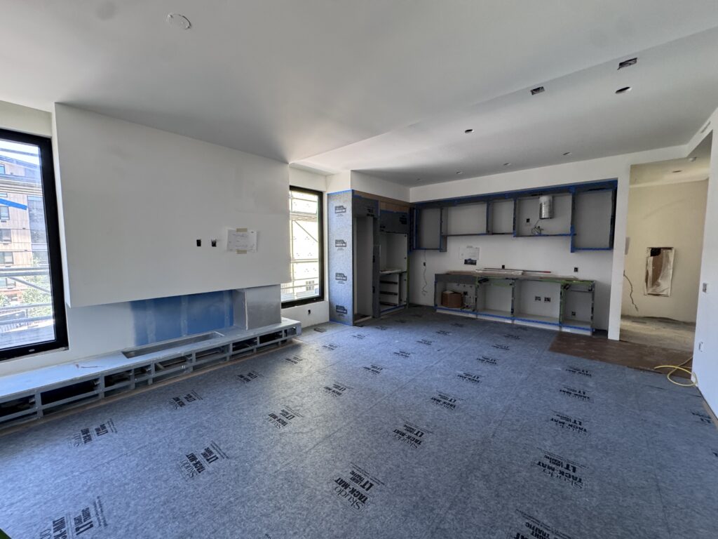 Progress continues in the west building as drywall wraps up and cabinetry installation brings each residence one step closer to completion. 