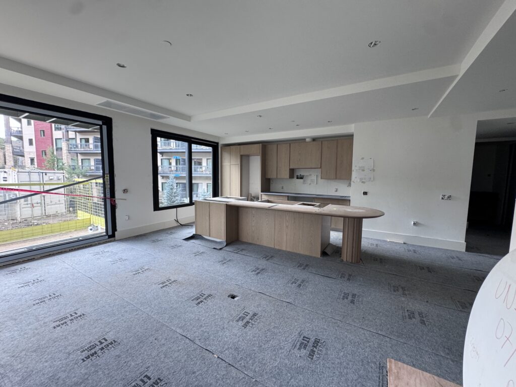 Progress continues in the West Building as flooring installation begins on the upper levels, while kitchen millwork and countertop installations continue to bring the residences' interior finishes together. 